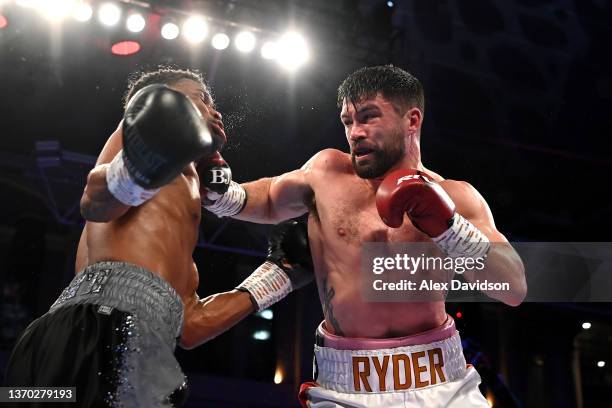 John Ryder punches Daniel Jacobs during the super-middleweight fight between Daniel Jacobs and John Ryder at Alexandra Palace on February 12, 2022 in...