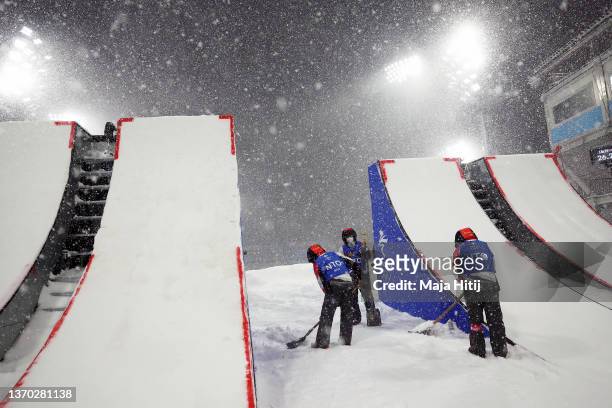 Officials tend to the course as the event is postponed during the Women's Freestyle Skiing Aerials Qualification on Day 9 of the Beijing 2022 Winter...