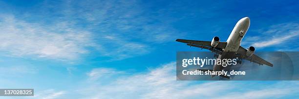 jet airplane landing in bright sky - airplane take off stock pictures, royalty-free photos & images