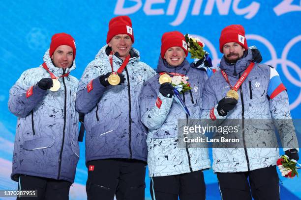 Gold medallists Alexey Chervotkin, Alexander Bolshunov, Denis Spitsov and Sergey Ustiugov of Team ROC pose with their medals during the Men's...