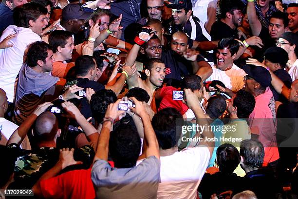 Jose Aldo celebrates in the crowd after defeating Chad Mendes in a featherweight bout during UFC 142 at HSBC Arena on January 14, 2012 in Rio de...