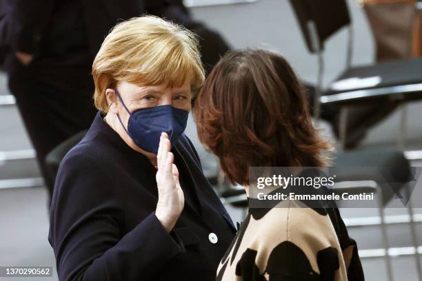 Former German Chancellor Angela Merkel talks with German Foreign Minister Annalena Baerbock during the Federal Assembly to elect Germany's next...