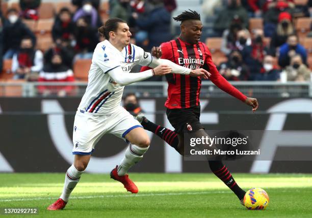 Rafael Leao of AC Milan competes for the ball with Giangiacomo Magnani of UC Sampdoria during the Serie A match between AC Milan and UC Sampdoria at...