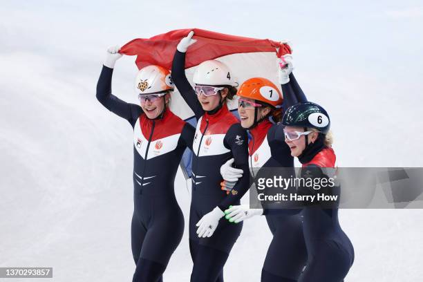Yara van Kerkhof, Selma Poutsma, Suzanne Schulting and Xandra Velzeboer of Team Netherlands celebrate winning the Gold medal in a new Olympic Record...