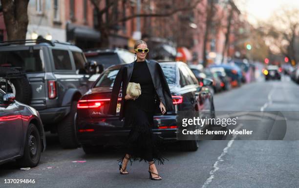 Leonie Hanne is is seen wearing yellow shades, a black leather jacket and a black dress and is seen outside Proenza Schouler during New York City...