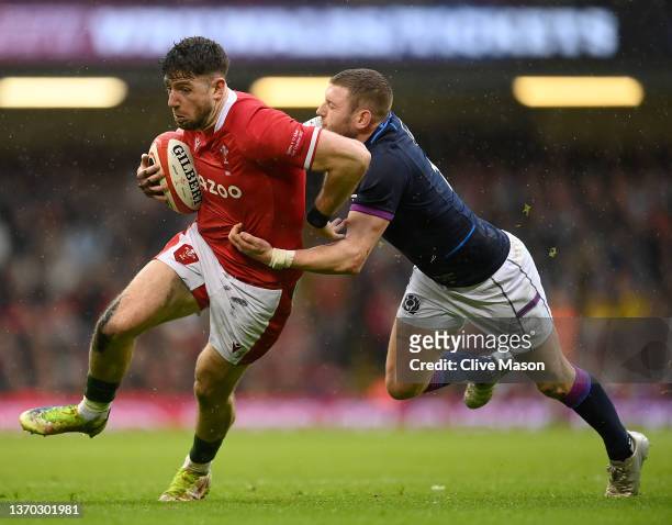 Alex Cuthbert of Wales is tackled by Finn Russell of Scotland during the Guinness Six Nations match between Wales and Scotland at Principality...