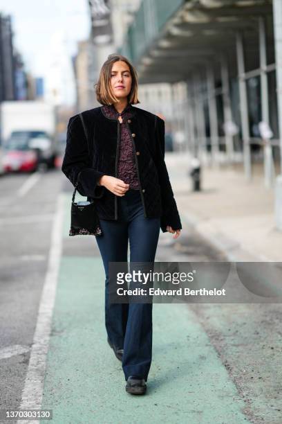 Guest wears a brown burgundy ruffled embroidered pattern high neck t-shirt, a black velvet buttoned jacket, a black nylon with purple / green / black...