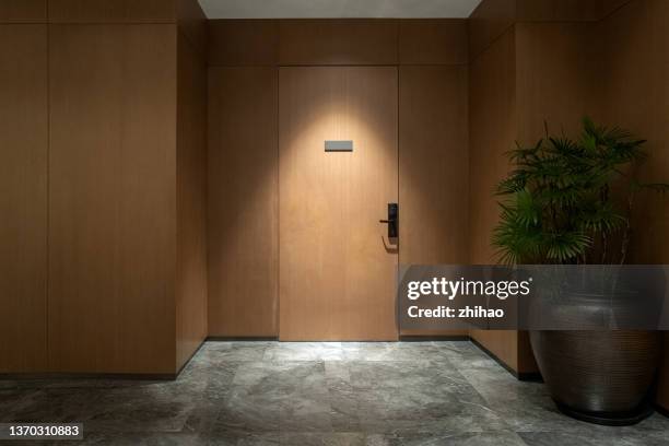 lights illuminate the door - apartment door stock pictures, royalty-free photos & images