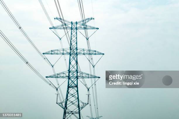 power transmission towers and high-voltage lines - high voltage sign stock pictures, royalty-free photos & images