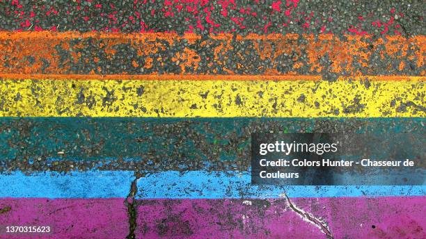 lgbt+ flag painted and weathered on a textured street in paris - all love is equal fotos in paris stockfoto's en -beelden