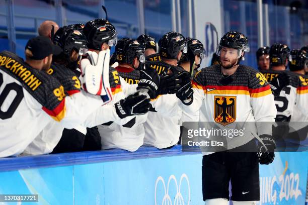 Tom Kuhnhackl of Team Germany congratulated by team mates after scoring during the Men's Ice Hockey Preliminary Round Group A match between Team...
