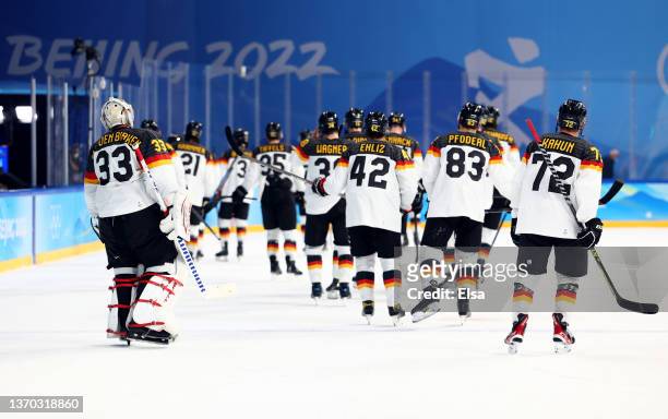 Team Germany players react following their defeat during the Men's Ice Hockey Preliminary Round Group A match between Team United States and Team...