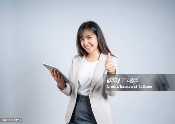 woman use of tablet and thumb up - black thumbs up white background stock pictures, royalty-free photos & images