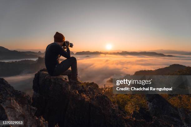 tourist enjoys sunset with camera at phu pha mok view point at baan ja bo in mae hong son province, thailand. - wilderness stock pictures, royalty-free photos & images