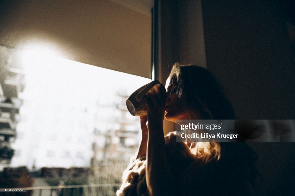 Middle-aged woman enjoying her morning coffee.