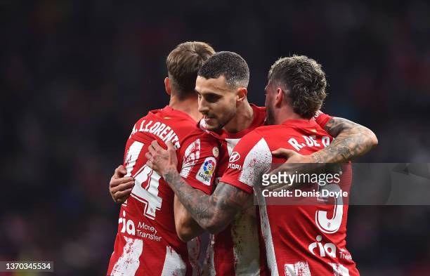 Mario Hermoso of Atletico de Madrid celebrates with Marcos Llorente and Rodrigo de Paul after scoring their team's fourth goal during the LaLiga...