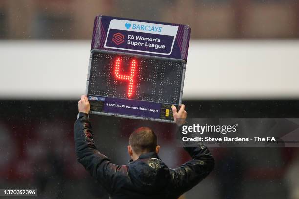 The Fourth Official holds up the LED panel showing how much extra time is to be played during the Barclays FA Women's Super League match between...