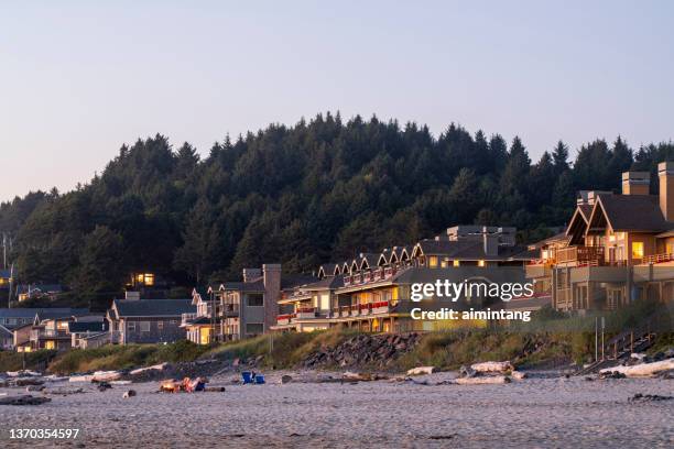 people sitting on chairs on cannon beach - oregon coast stock pictures, royalty-free photos & images