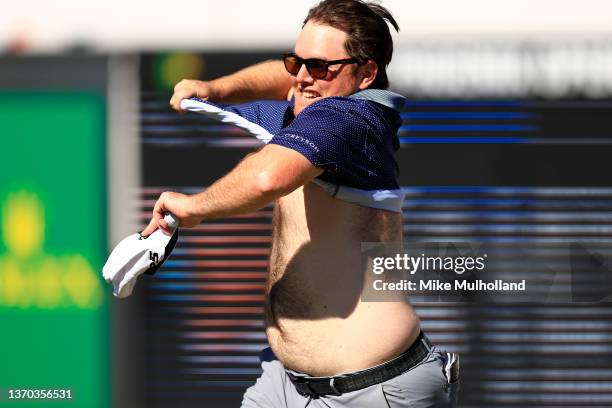 Harry Higgs of the United States takes his shirt off on the 16th hole during the final round of the WM Phoenix Open at TPC Scottsdale on February 13,...