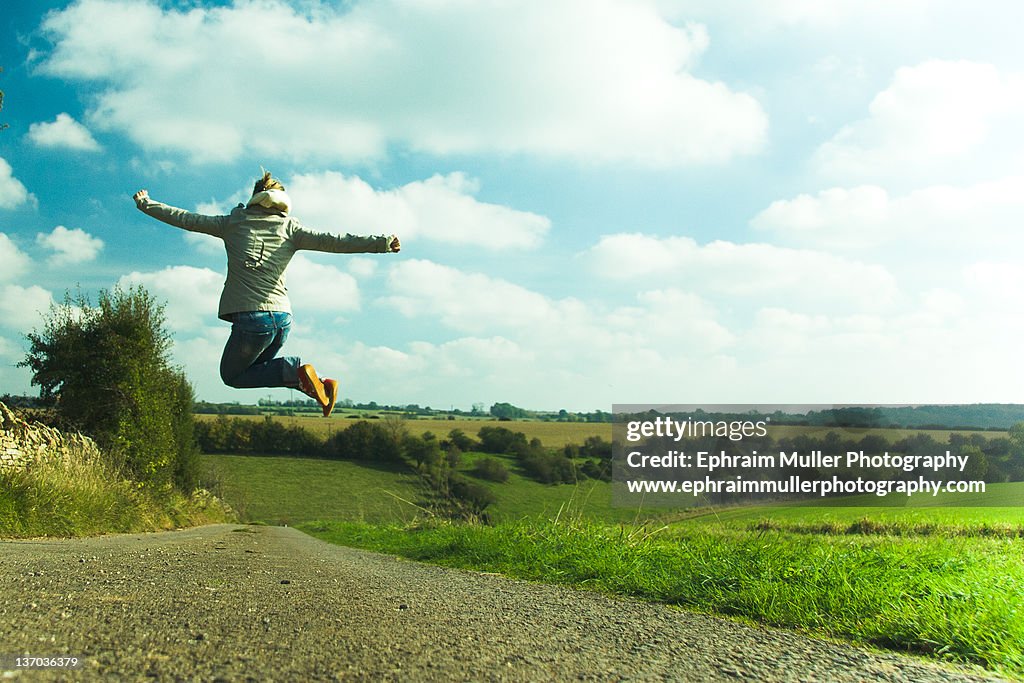 Girl jumping in field