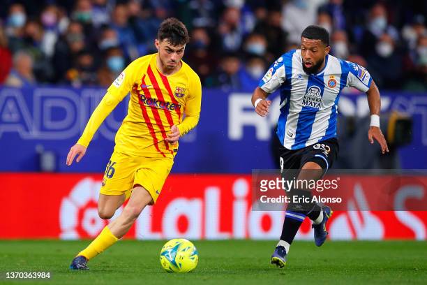 Tonny Vilhena of RCD Espanyol competes for the ball with Pedro 'Pedri' of FC Barcelona during the LaLiga Santander match between RCD Espanyol and FC...