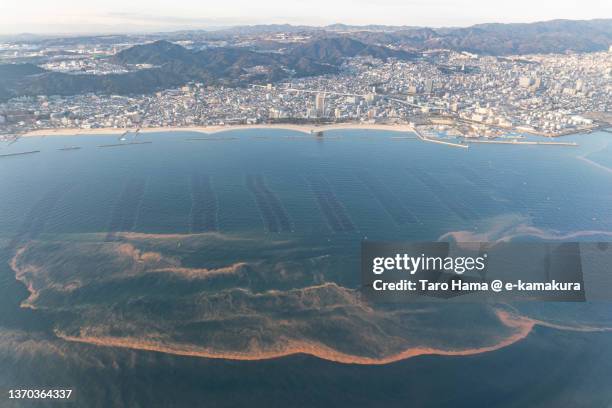 red tide on seto inland sea in kobe city of japan aerial view from airplane - red_tide stock pictures, royalty-free photos & images