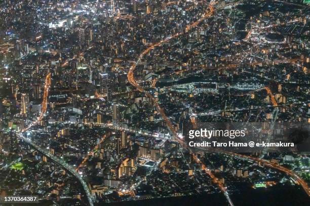 illuminated osaka city of japan aerial view from airplane - the hague netherlands stock pictures, royalty-free photos & images