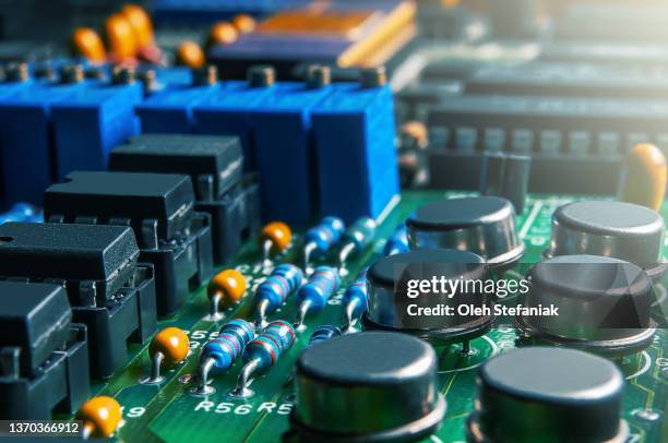 Closeup of Printed Circuit Board with integrated circuits and many other passive electrical components.