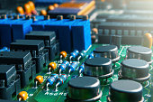 Closeup of Printed Circuit Board with  integrated circuits and many other passive electrical components.
