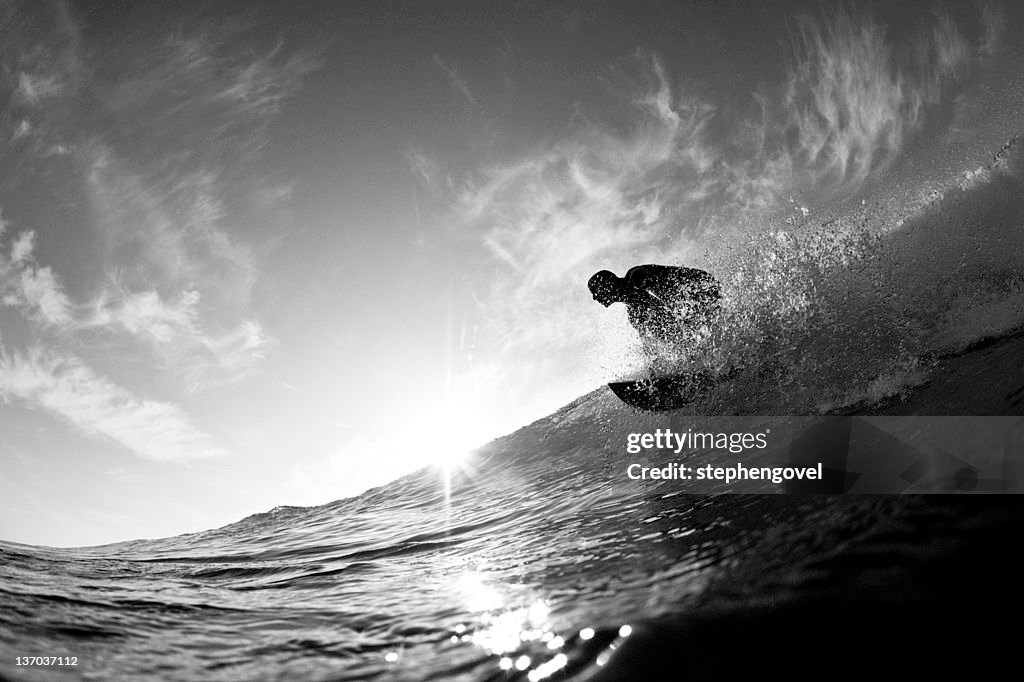 Surfer catching wave