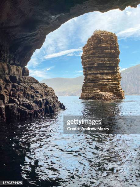 rock formation viewed from inside sea cave, tasmania australia - grotte stock-fotos und bilder