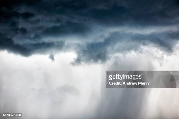 dark storm clouds with rain falling, close up - thunderstorm ocean blue stock-fotos und bilder