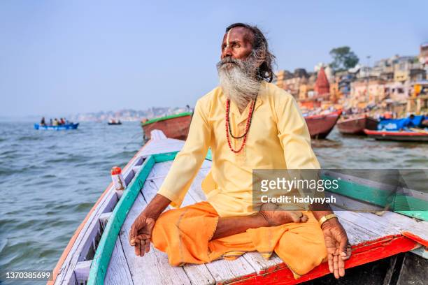 sadhu ist meditieren in einem boot auf den heiligen ganges, varanasi - varanasi stock-fotos und bilder