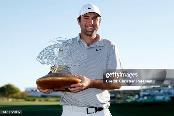 Scottie Scheffler of the United States poses with the trophy after winning the WM Phoenix Open at TPC Scottsdale on February 13, 2022 in Scottsdale,...