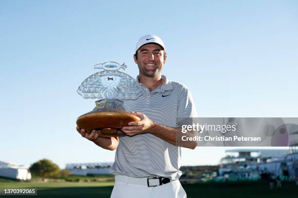 Scottie Scheffler of the United States poses with the trophy after winning the WM Phoenix Open at TPC Scottsdale on February 13, 2022 in Scottsdale,...