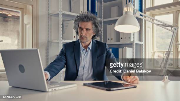 businessman working with music. having fun at work. active senior man listening to music while working in the office. architect in his creativity process. - funky office stock pictures, royalty-free photos & images