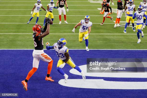 Tee Higgins catches a touchdown pass from Joe Mixon of the Cincinnati Bengals over Nick Scott of the Los Angeles Rams during the second quarter of...