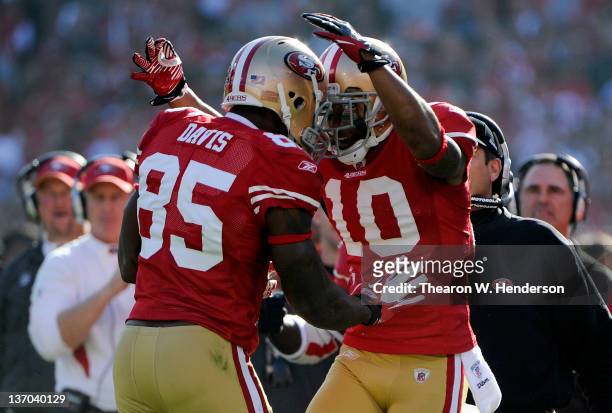 Vernon Davis and Kyle Williams of the San Francisco 49ers celebrates after Davis goes forty nine yards on a pass play for a touchdown against the New...