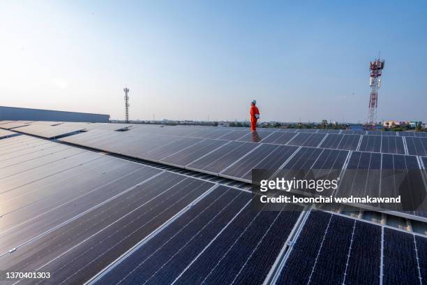 technology solar cell, engineer service check installation solar cell on the roof of factory on the morning. - solar panel stock pictures, royalty-free photos & images