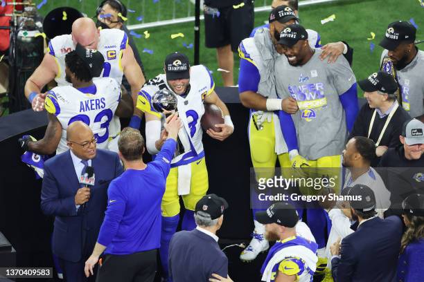 Head coach Sean McVay of the Los Angeles Rams hands the Vince Lombardi Trophy to Matthew Stafford after Super Bowl LVI at SoFi Stadium on February...
