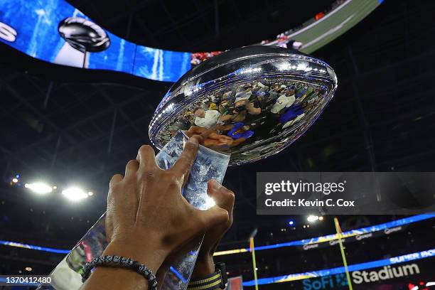 The Vince Lombardi Trophy is held in the air after Super Bowl LVI at SoFi Stadium on February 13, 2022 in Inglewood, California. The Los Angeles Rams...