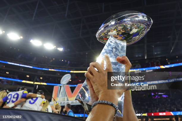 The Vince Lombardi Trophy is held in the air after Super Bowl LVI at SoFi Stadium on February 13, 2022 in Inglewood, California. The Los Angeles Rams...