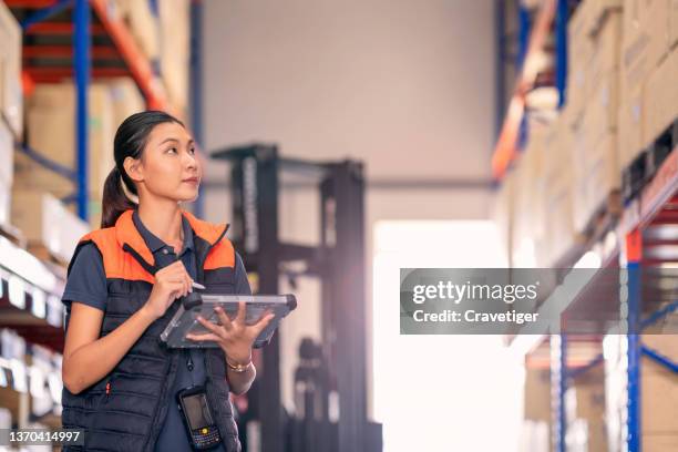 the portrait of logistic officer checking warehouse batch. - diversity people industry stock-fotos und bilder