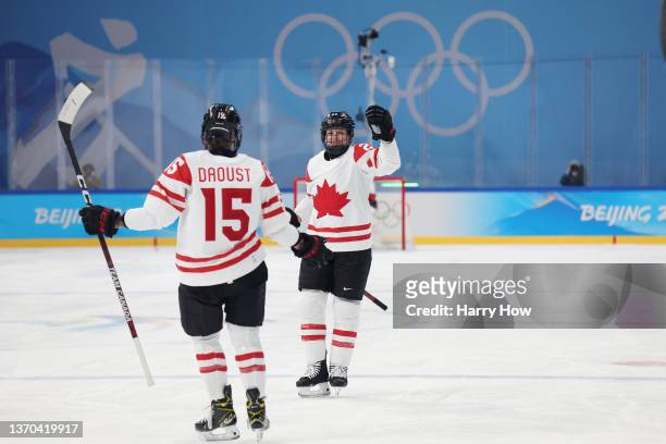 Erin Ambrose of Team Canada celebrates with Melodie Daoust after Ambrose scored a goal in the first period during the Women's Ice Hockey Playoff...