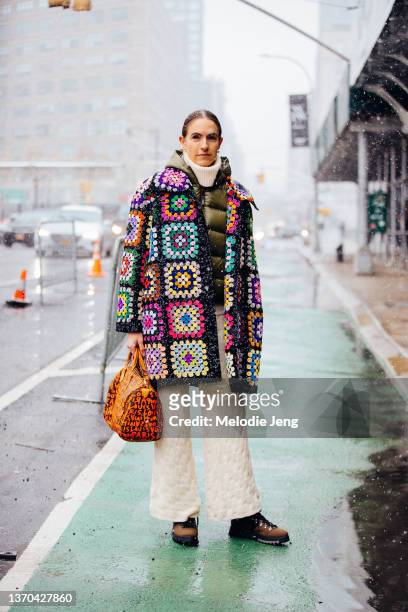 Gigi Guerra wears a colorful knit patch-style Ashish top, tan knit cashmere Rachel Comey for Target pants, an orange Louis Vuitton graffiti monogram...