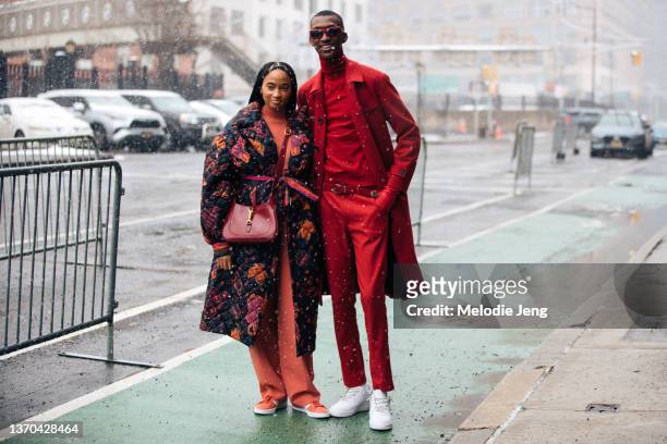 Candace Marie Stewart and Alioune Fall wear red outfits at the In the BLK show at Spring Studios on February 13, 2022 in New York City. Candace wears...