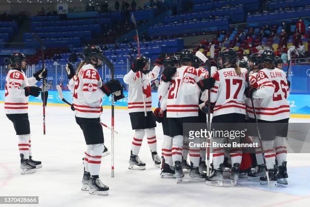 Team Canada celebrate around goaltender Ann-Renee Desbiens on the ice after their 10-3 win in the Women's Ice Hockey Playoff Semifinal match between...