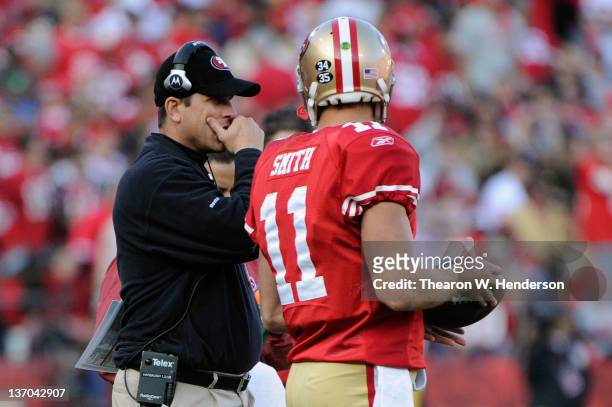 Head coach Jim Harbaugh of the San Francisco 49ers talks with quarterback Alex Smith in the third quarter against the New Orleans Saints during the...