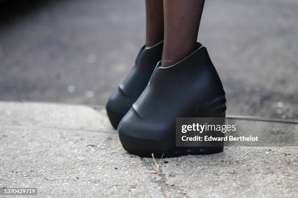 Guest wears black tights, black shiny leather oversized wedge platform ankle shoes, outside Saint Sintra, during New York Fashion Week, on February...