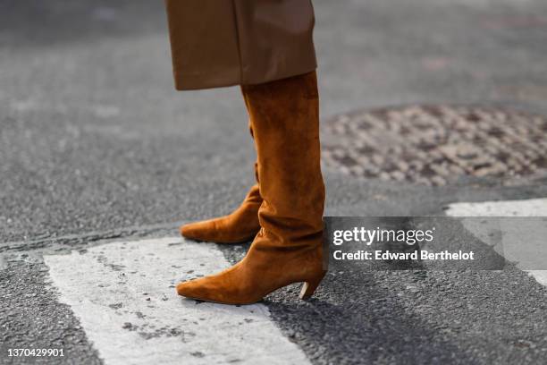 Guest wears brown shiny leather shorts, camel suede pointed heels ankle boots, outside Jason Wu , during New York Fashion Week, on February 12, 2022...